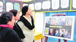 Visitors look at Mukesh Paharis works at his exhibition in Dehradun on Tuesday.