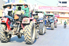 People involved in river bed quarrying take out a procession on tractors in Haridwar on Tuesday.