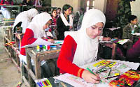 Students participate in a painting competition organised by the Army at Government Girls Higher Secondary School in Doda