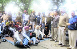 Members of the Punjab Government Transport Workers Union raise slogans against the state government during a gate rally at Jagraon