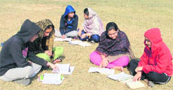 Students exchange notes at a ground in Khalsa College for Women, Ludhiana
