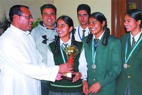 Students of St. Xavier's school, who won silver at national school games, being honoured by the principal Fr. Ivo Dias in Bathinda