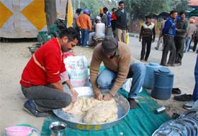 Unemployed linemen preparing meal during their ongoing agitation in front of the Mini-secretariat in Bathinda on Tuesday