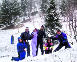 Tourists enjoy a fresh spell of snow near Gulaba on the Manali-Rohtang Pass road on Wednesday