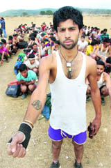 A candidate shows the tattoo on his arm.
