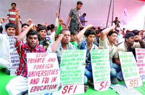 Activists of the SFI demonstrate against the entry of foreign universities in India and FDI in the education sector at Parliament Street in New Delhi on Thursday. 