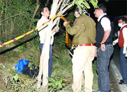 A policeman at the spot where a bag containing a womans chopped body was found.