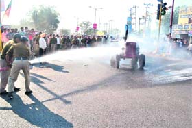 Fire police personnel douse a burning tractor set ablaze by pro-quarrying supporters in Haridwar on Thursday