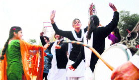 Students dance to drum beats at the Red Cross Mela at Government College for Women in Jammu on Thursday.