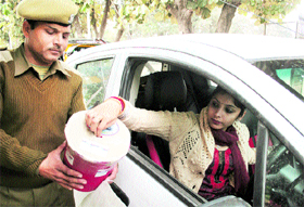 A woman donates money for the Armed Forces Flag Day Fund at the University of Jammu on Thursday.
