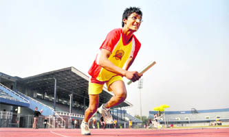 An athlete takes part in a relay race during the junior championship league at Guru Nanak Stadium in Ludhiana on Thursday.