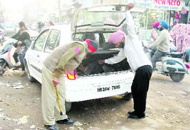Police personnel checking a car in Patiala on Thursday