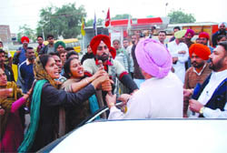 A harassed commuter (in pink turban) argues with protesting ETT teachers (EGS) during the traffic blockade by the latter in front of the Civil Hospital in Bathinda on Friday