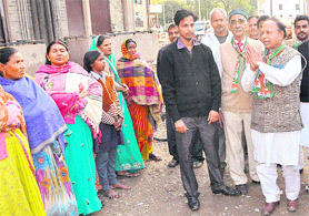 BJP candidate, Ram Lal (with folded hands) from Ward No. 13, interacts with voters at Colony No. 5 in Sector 50, Chandigarh, on Friday. 
