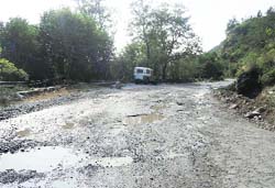 A potholed stretch of the Talwara-Shiar Bawa road, near the Reasi district headquarters