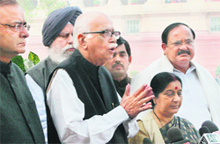BJP leaders LK Advani, Arun Jaitley, Sushma Swaraj and Venkaiah Naidu talk to mediapersons outside Parliament in New Delhi on Friday. 