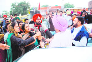 EGS teachers argue with a commuter (in pink turban) during a blockade in Bathinda on Friday.