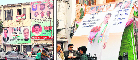 BJP and Congress hoardings put up at the Sector-20 market in Chandigarh on Saturday.