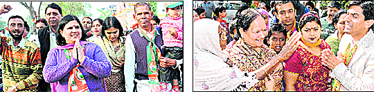Congress candidate Anu Chatrath; and (right) BJP candidate Saurabh Joshi (with folded hands) campaign at Sector 15, Chandigarh, on Saturday.