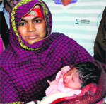 The stolen newborn in the lap of his mother at Panchkula on Saturday. 