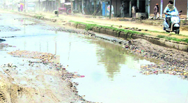 A waterlogged portion of the Raikot Road after a brief shower.
