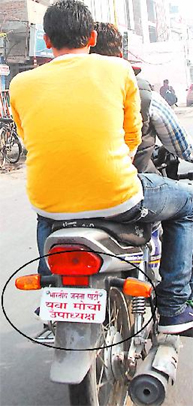Flouting the norms, youth hide the number plate of their bike in Bathinda.