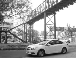 The steel structure of a footbridge that has been erected adjoining the Phase 3BI Rose Garden in Mohali