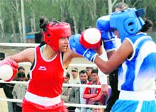 Shabana (red) of Delhi and Sonam Nayak of MP in action during senior women boxing championship in Dehradun on Sunday