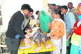 Team members from Saket Orthopaedic Hospital, Panchkula, examine a physically challenged person at a free camp organised by the Nar Narain Sewa Samiti at Shahabad Markanda, Kurukshetra. 