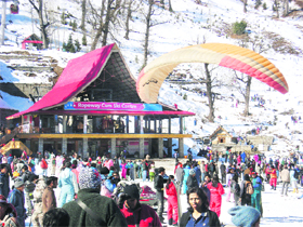 Tourists throng the Snow Point at Solang Valley, near Manali, to enjoy snow on Sunday. 