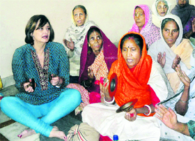 Cherrie Blair, wife of former UK Prime Minister Tony Blair, sings religious songs with other devotees at an ashram in Vrindavan near Mathura on Sunday.