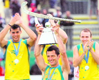 Jamie Dwyer (C) of Australia celebrates with the trophy after beating Spain in the Champions Trophy in Auckland on Sunday.
