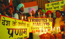 Members of the All-India Anti-Terrorist Front take out a candlelight march on the eve of the 10th anniversary of militants attack on Parliament in Amritsar