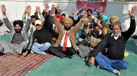 Medical laboratory technicians stage dharna on the Civil Hospital premises on Monday.