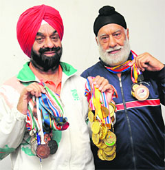 (Left) PS Sidhu and elder brother GS Sidhu strike a pose with their medals in Chandigarh