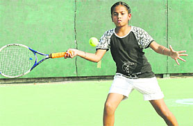 A girl plays a shot during a tennis match in Chandigarh on Monday. 