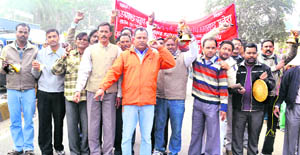 Grade IV employees protest on the national highway in Haridwar on Monday. 