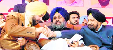 Deputy CM Sukhbir Singh Badal (centre) along with Balwant Singh Ramoowalia (right) and MP Navjot Singh Sidhu (left) at a rally in Tarn Taran on Sunday. Photo: Vishal Kumar