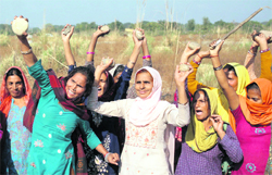 Women protest against the Jammu Municipal Corporation for dumping garbage at Kangryl in Jammu on Monday.