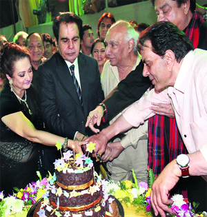 Veteran actor Dilip Kumar, with wife Saira, cuts the cake during his 89th birthday celebrations in Mumbai on Saturday evening. Also seen in the picture is Yash Chopra.