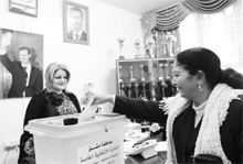 A Syrian woman votes to elect representatives to the local administration councils in Damascus on Monday.