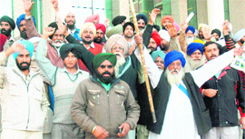 Farmers stage a protest outside GMADAs office in Mohali on Tuesday.