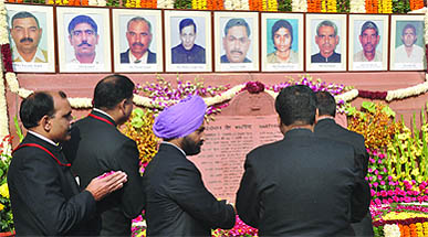Parliament security officers pay tribute to their colleagues who died in the 2001 attack on Parliament during an event to mark the 10th anniversary of the attack, in New Delhi, on Tuesday.