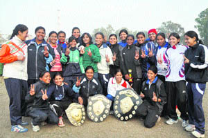 The winning team of boxers from Delhi and the runners-up from Madhya Pradesh with their trophies of the 5th Central India Senior Womens Boxing Championship in Dehradun on Tuesday. 