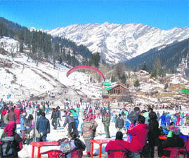 Tourists enjoy paragliding in the Solang Valley, 13 km from Manali. 