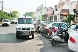 A police vehicle parked illegally outside a restaurant on Malhar Road, Ludhiana, on Tuesday. 