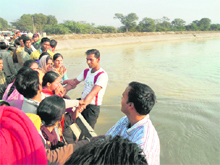 Teachers prevent two of their colleagues from attempting to jump into a canal near Gidderbaha on Tuesday. 