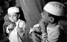 SCARED AND SCARRED: Children cry after being rescued after a police raid on Madrassa Zakariya in Karachi on Monday night