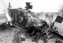 An armoured vehicle burns after it struck an IED near Kandahar in this photo taken in July 2010. The US Congress wants to freeze $700 million aid to Pakistan until it provides an 