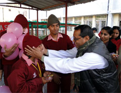 Principal of the St. Xaviers school Father Ivo Dias greets a child at the Asha School being run for the special students by the Army Wives Welfare Association (AWWA) at the Bathinda Military Station on Wednesday
